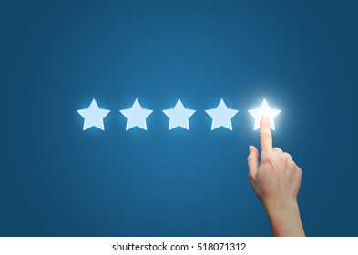 Businesswoman pointing five star to increase