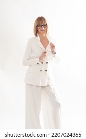 Businesswoman Portrait, White Suit, Sitting And Posing On A Chair 