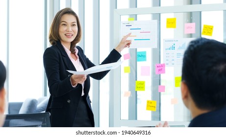 Businesswoman Presenting Business Plan Information To Team At Office Meeting, Asian Leader Woman Explaining Business Chart For Teamwork, Business People, Success In Business Concept