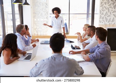 Businesswoman presenting to colleagues at a meeting - Shutterstock ID 275800298