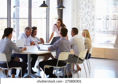 Businesswoman presenting to colleagues at a meeting