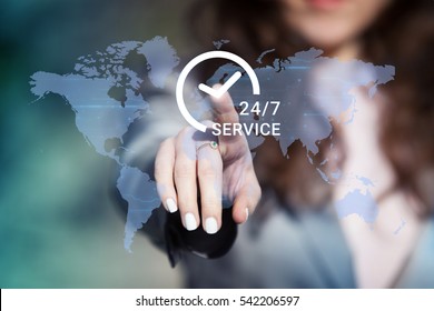 Businesswoman pressing 24/7 support service button on world map on touch screen. Customer service concept.