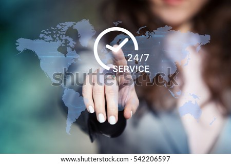Businesswoman pressing 24/7 support service button on world map on touch screen. Customer service concept.
