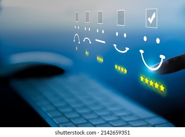 Businesswoman pressing face emoticon on virtual touch screen at laptop. Customer Service Excellence Assessment Concept - Shutterstock ID 2142659351