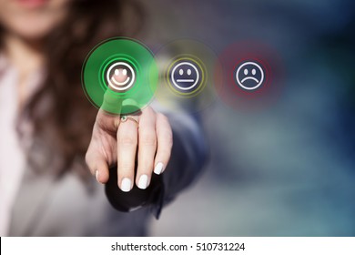 Businesswoman pressing smiley face emoticon on virtual touch screen. Customer service evaluation concept.
