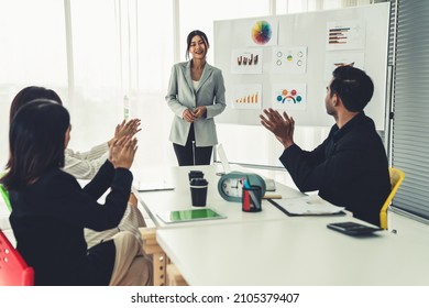 Businesswoman proficiently present work project receive celebrations from team . Corporate business team collaboration concept . - Shutterstock ID 2105379407