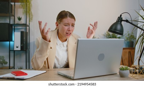 Businesswoman programmer software developer in suit working on laptop loses becoming surprised sudden lottery results, bad news, fortune loss, fail at office. Concentrated freelancer business woman - Shutterstock ID 2194954583