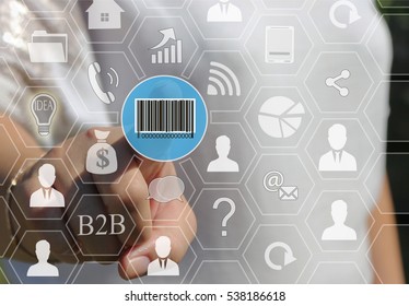 Businesswoman pushing button with the icon of the barcode on the touch screen