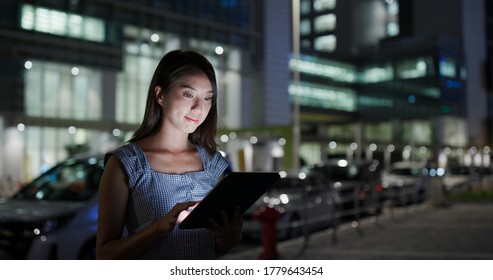 Businesswoman read on tablet computer at outdoor at night - Shutterstock ID 1779643454