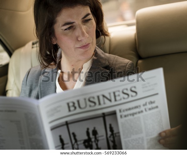 Businesswoman Reading\
Newspaper Car\
Inside