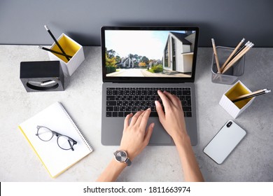 Businesswoman or real estate agent looking through online property portfolio, top view - Shutterstock ID 1811663974
