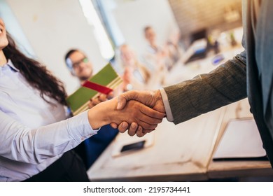 Businesswoman receiving award from businessman in front of business professionals, applauding at business seminar in office building. Close up. - Powered by Shutterstock