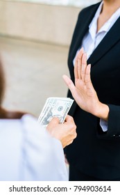 Businesswoman Refusing Money Offered By A Woman - Anti Bribery And Corruption Concepts