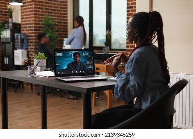 Businesswoman In Remote Videocall Conference With Executive Officer While Sitting At Desk In Office Workspace. Financial Advisor Informing African American Team Leader About Possible Bankruptcy Event.