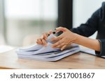 Businesswoman Reviewing Documents: A close-up of a businesswoman