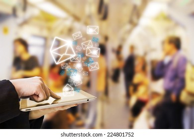 Businesswoman sending email in skytrain