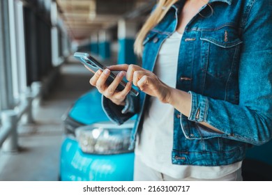 Businesswoman Sending A Message With A Smartphone. A Young Proud Businesswoman Is Talking On Her Mobile Phone With A Client And Reading Order. Woman Standing Nearby Car Texting Message On A Smartphone