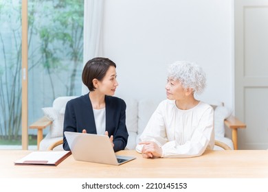 Businesswoman And Senior Woman Looking At Laptop Computer