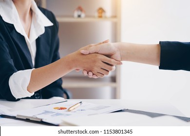 Businesswoman shaking hand for a complete business deal together successful, finishing up a meeting. Teamwork concept. Partnership concept and dealership concept.