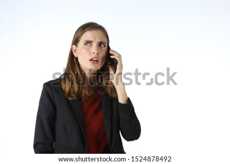 Businesswoman show of mobile phone. Businesswoman talking on the phone and showing a lot of emotions. 