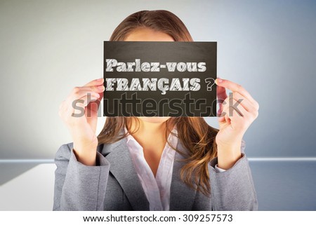 Businesswoman showing card against room with shadow and light