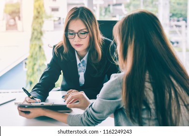 Businesswoman signing business document at meeting with partners team, satisfied client customer agreeing to put signature on contract agreement buying services or taking bank loan concept