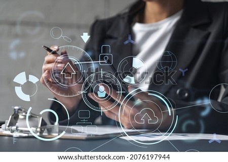 Businesswoman is signing the contract to create fin-tech start up for the conference and gain investments for innovative service. Checking the details at smartphone. Hologram tech graphs.