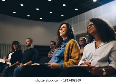 Businesswoman Sitting In The Audience And Laughing During A Corporate Event. Business People Smiling During A Seminar.