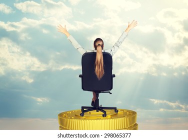 Businesswoman sitting in chair on coins stack and looking up, rear view - Shutterstock ID 298065377