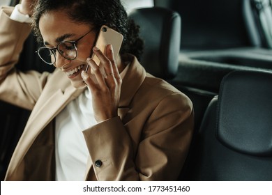 Businesswoman Sitting In Her Car And Talking On Phone. Woman In Businesswear Making A Phone Call While Sitting In Her Car.