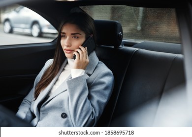 Businesswoman Sitting In Her Car And Talking On Phone. Woman In Businesswear Making A Phone Call While Sitting In Her Car.