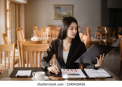 Businesswoman sitting working at restaurant. , and drink a coffee - Shutterstock ID 1340428436