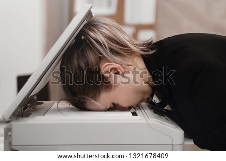 Businesswoman sleeping on printer at office. Overworked concept.