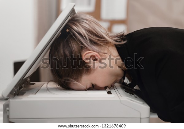 Businesswoman sleeping on printer at office.\
Overworked\
concept.