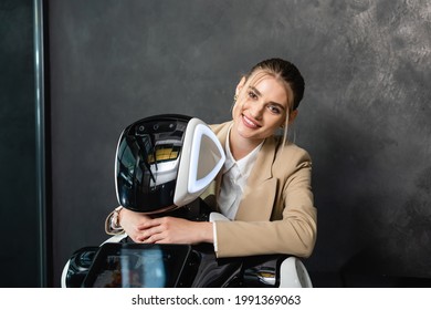 businesswoman smiling at camera while embracing robot in office