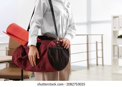 Businesswoman With Sports Bag In Office, Closeup