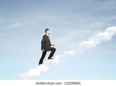 businesswoman up stairs out of clouds - Powered by Shutterstock