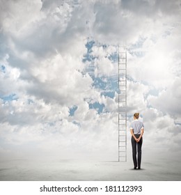 Businesswoman standing with back near long ladder to sky