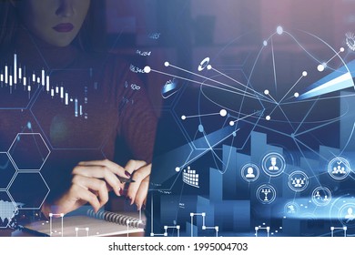 Businesswoman Or Stock Trader Analyzing Stock Graph Chart Using Laptop In Office At Night. Trading Strategy Building. Educational And Social Mediaa Icons. Looking For A Job At Financial Sector Concept