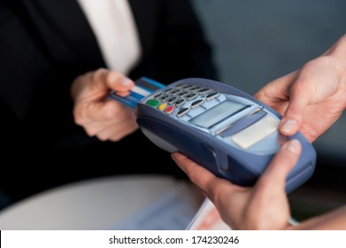 Businesswoman Swipes Her Credit Card To Make The Payment