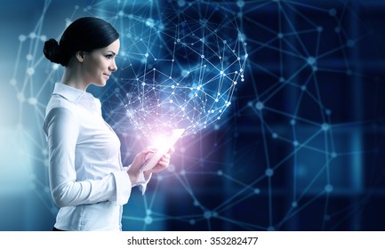 Businesswoman with tablet pc against high tech blue background