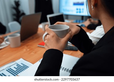 Businesswoman take coffee break, leisure in office after planning strategy, working in office for concept of harmony in workspace concept. Business office worker sitting professional meeting table. - Powered by Shutterstock