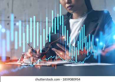 Businesswoman taking notes and forex graph hologram. Double exposure. Business technology online trading stock market solution concept.