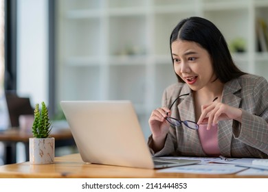 Businesswoman Taking Off Her Glasses Because She Can't Believe Her Eyes Excited To Receive Good News From My Boss Via Email. That She Was Promoted And Get A Big Bonus At The End Of This Year