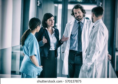 Businesswoman talking with doctors in hospital
