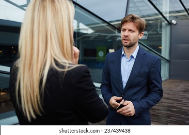 Businesswoman Talking With Her Business Partner Standing Near Skyscraper Office, Confident Businesspeople Having Serious Conversation About The Work, Boss Discussing With Employee