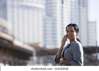Businesswoman talking on cell phone in urban setting