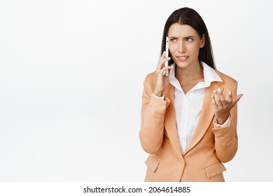 Businesswoman Talking On Mobile Phone With Confused Face, Having An Argument, Receive Strange Call, Standing Over White Background