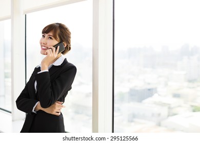 Businesswoman Talking On The Phone In The Office