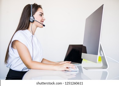 businesswoman talking on the phone while working on her computer at the office